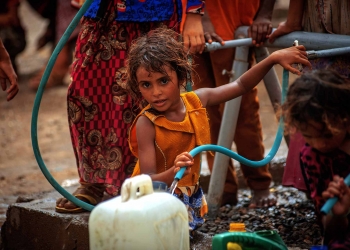 A girl fetch water provided by Solidarités International, an EU-supported aid group