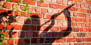 The shadow of a musician playing transverse flute