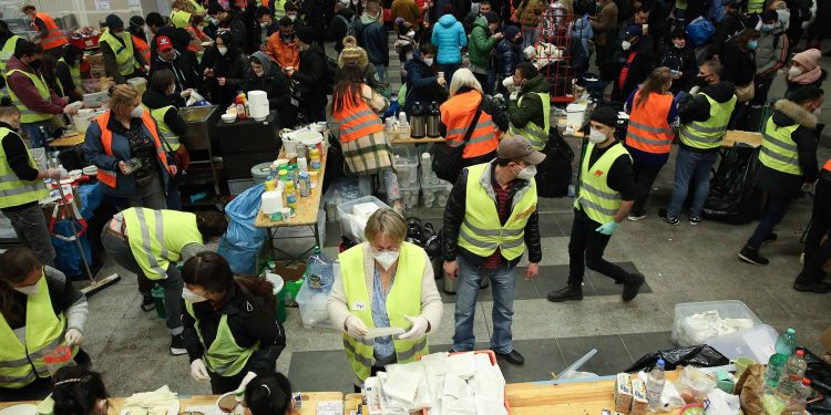 Volunteers preparing food for Ukrainian refugees arriving at Berlin Central Station